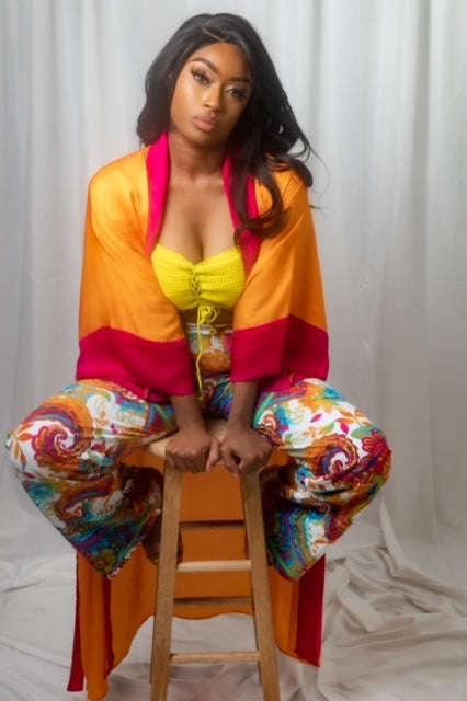 model in robe sitting on a stool